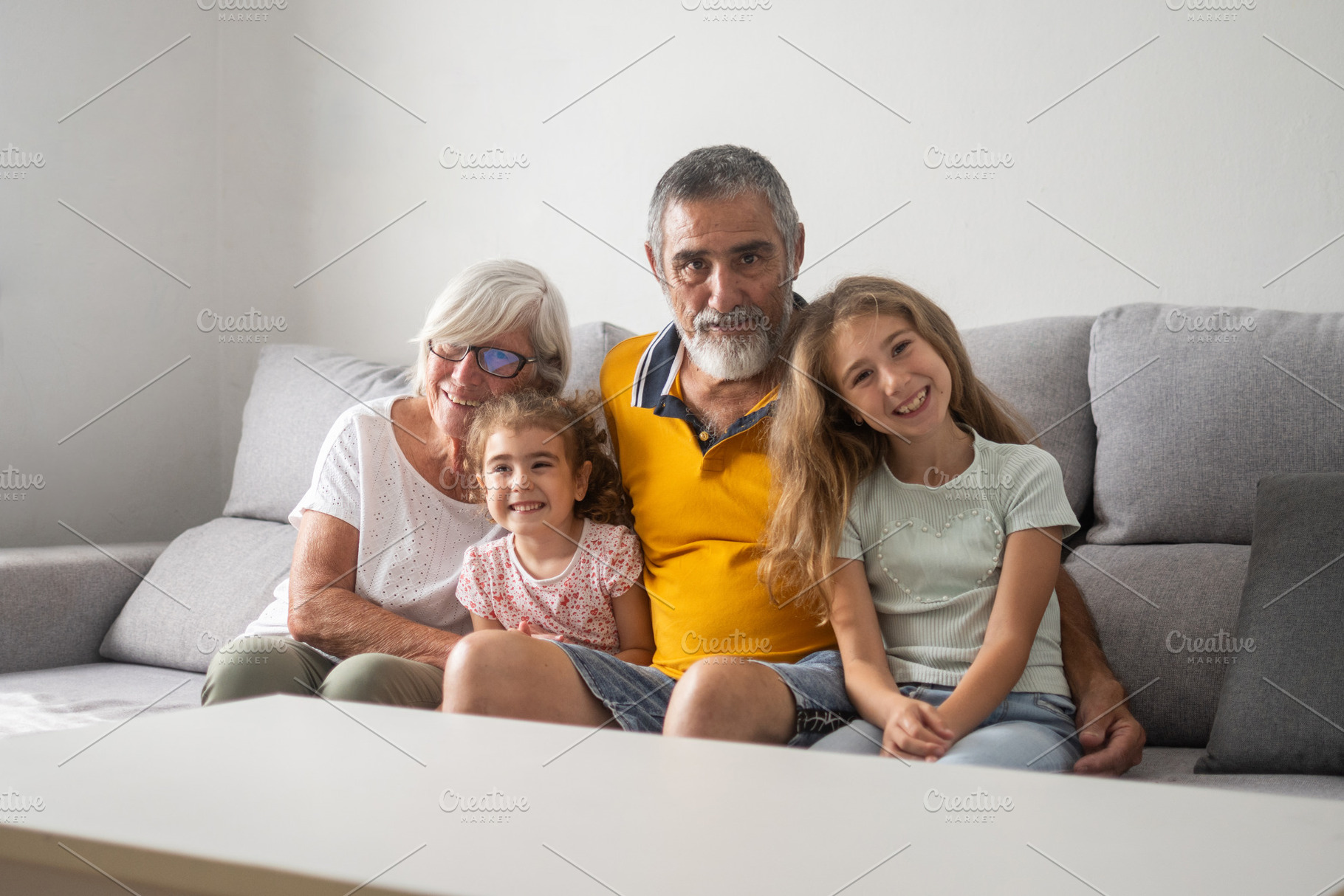 Happy multigenerational family sitting together on the sofa, a Person Photo by etorres69