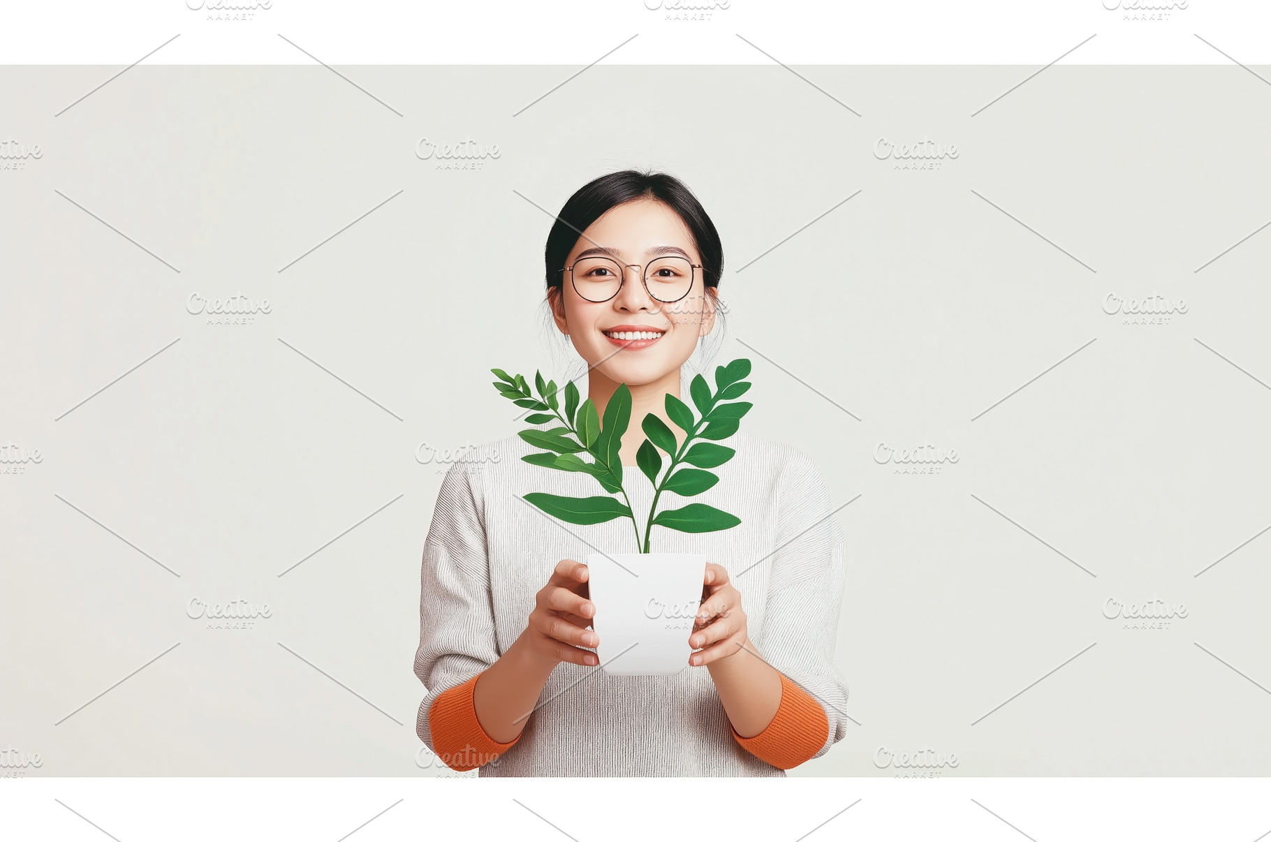 Asian woman holding a potted plant, a Person Photo by Sergey Kotenev
