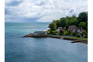 Houses along the shore by Fishbourne, an Architecture Photo by Backyard Stock