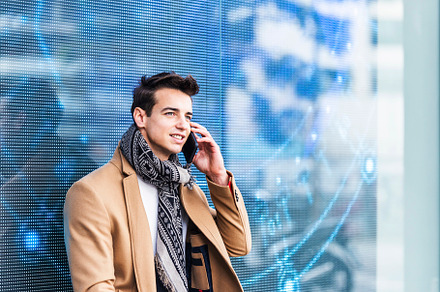 Portrait of stylish handsome young man with coat standing outdoo, a Person Photo by RF Images