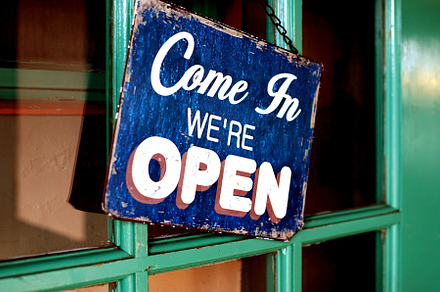 Open sign in old shop window