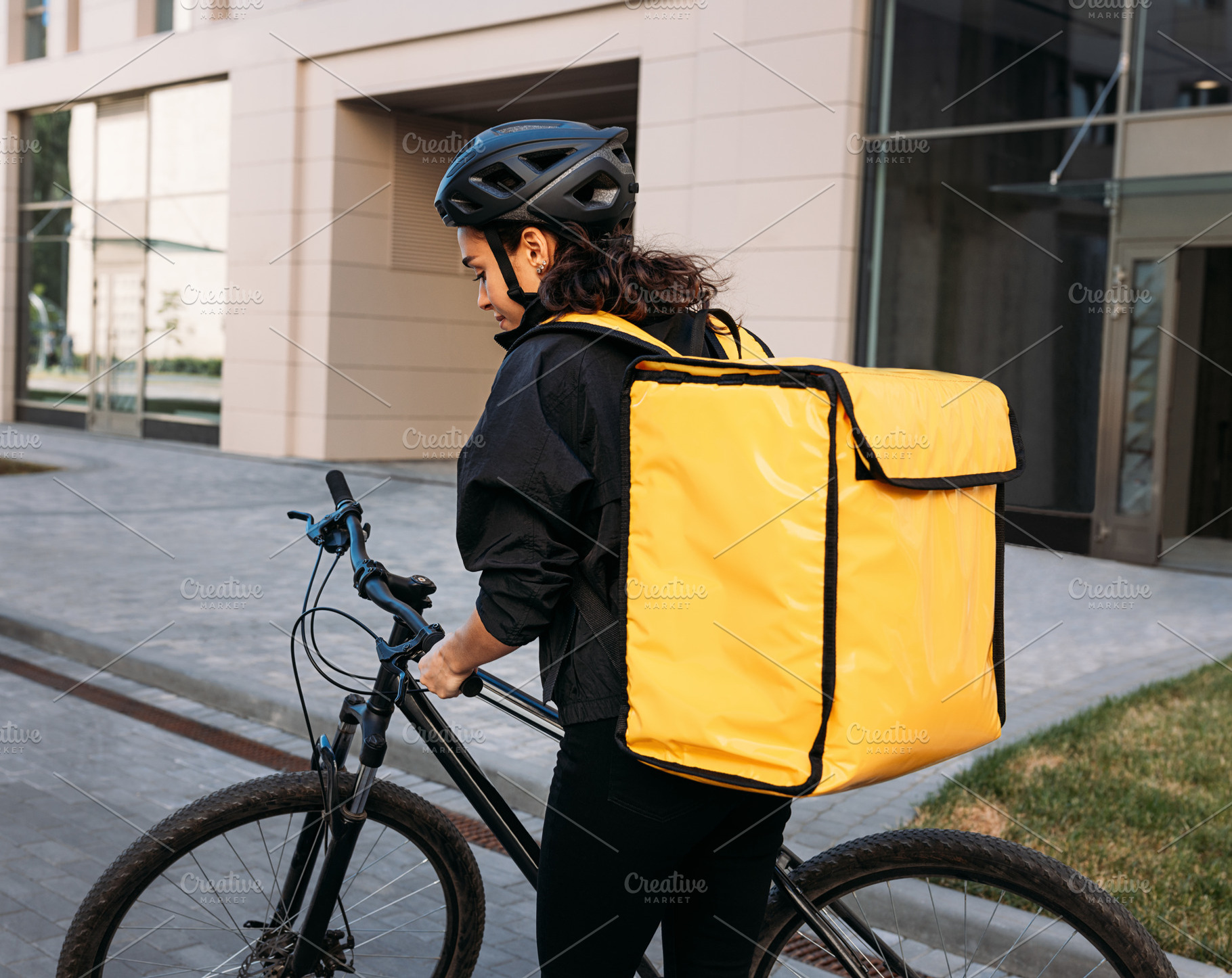 Back view of a female courier, a Person Photo by Artem Varnitsin