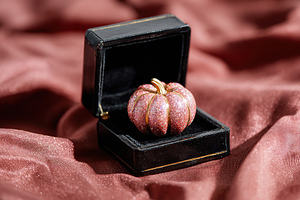Glossy pumpkin placed elegantly in a small black box on rich fabric backdrop, a Holiday Photo by AlyaAnd