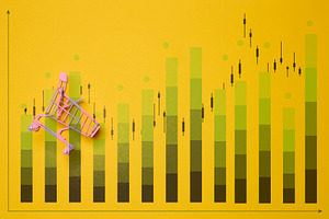 Pink shopping cart against a chart with green bars and black can, a Business Photo by ndanko
