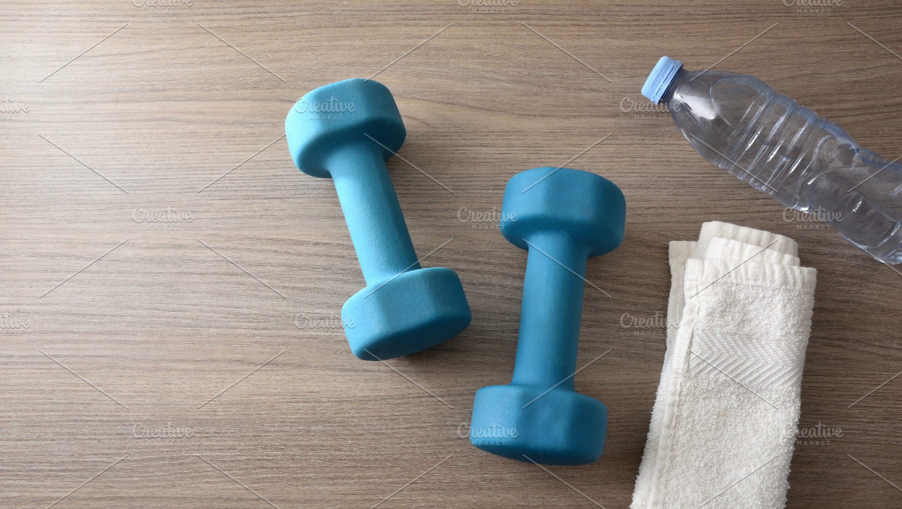Blue Dumbbells, Water Bottle and Towel on Wooden Surface, a Sports & Recreation Photo by Davizro's Market