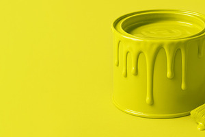 Chartreuse paint can with dripping lime color and brush on solid, a Photo by Dvoevnore photos