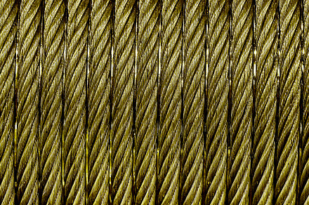 The texture of a new golden color cable wrapped in a spool. Abst, an Abstract Photo by Eugene_Photo