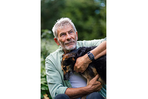 Older man spending quality time with, an Animal Photo by HalfPoint