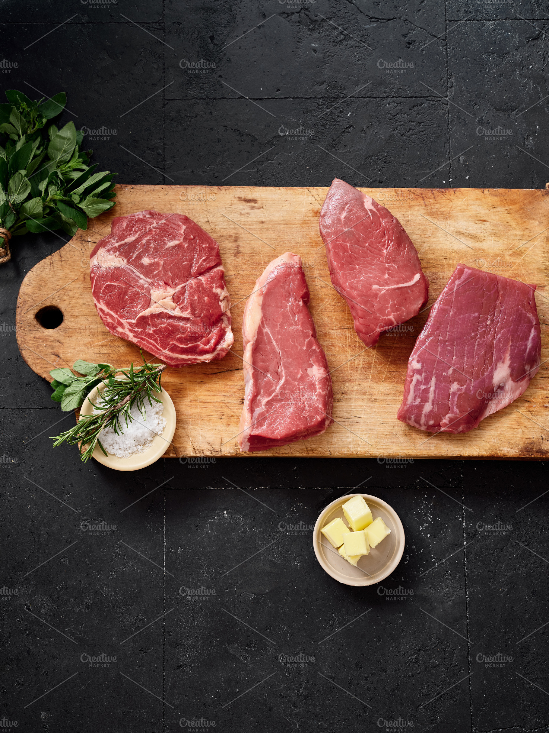 Raw rib-eye, roast beef, flank and rump steak displayed on a cutting board with, a Food & Drink Photo by Asya Nurullina