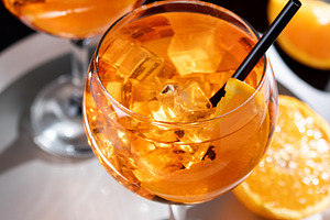 Refreshing Aperol Spritz cocktails with orange slices and ice in elegant glasse, a Food & Drink Photo by etorres69