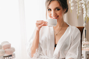 A young bride sits at a slot machine in the morning and drinks c