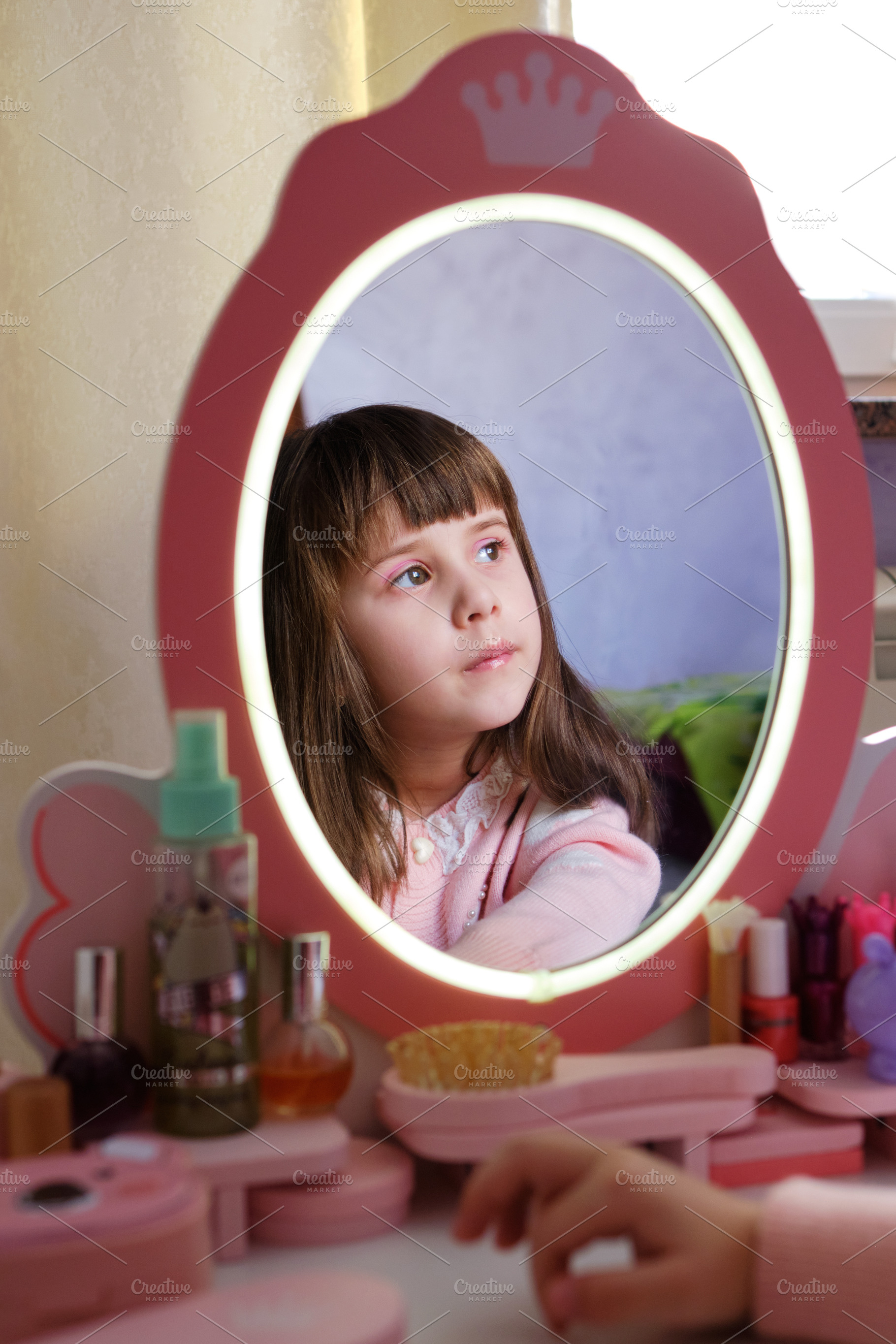 Dreamy preschooler child with pink makeup playing in her bedroom., a Person Photo by Rohan Photography