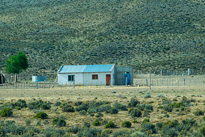 Rustic countryside house surrounded by the patagonian steppe lan, a Nature Photo by DanFLCreativo