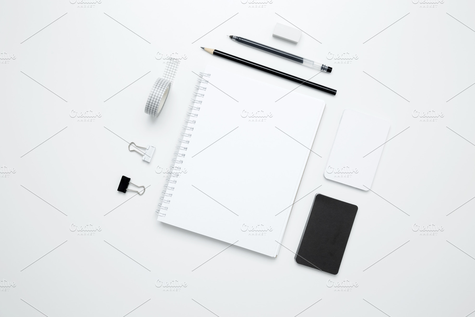 On a white background, an empty mock up notebook, white and black cards, and mo, a Photo by matucha