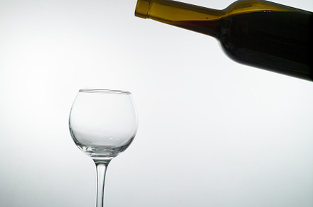 Red wine pouring into a wine glass containing wine, red, and drink, a Food & Drink Photo by oleghz