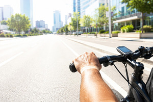 Cyclist riding on urban road under b, a Photo by Dvoevnore photos