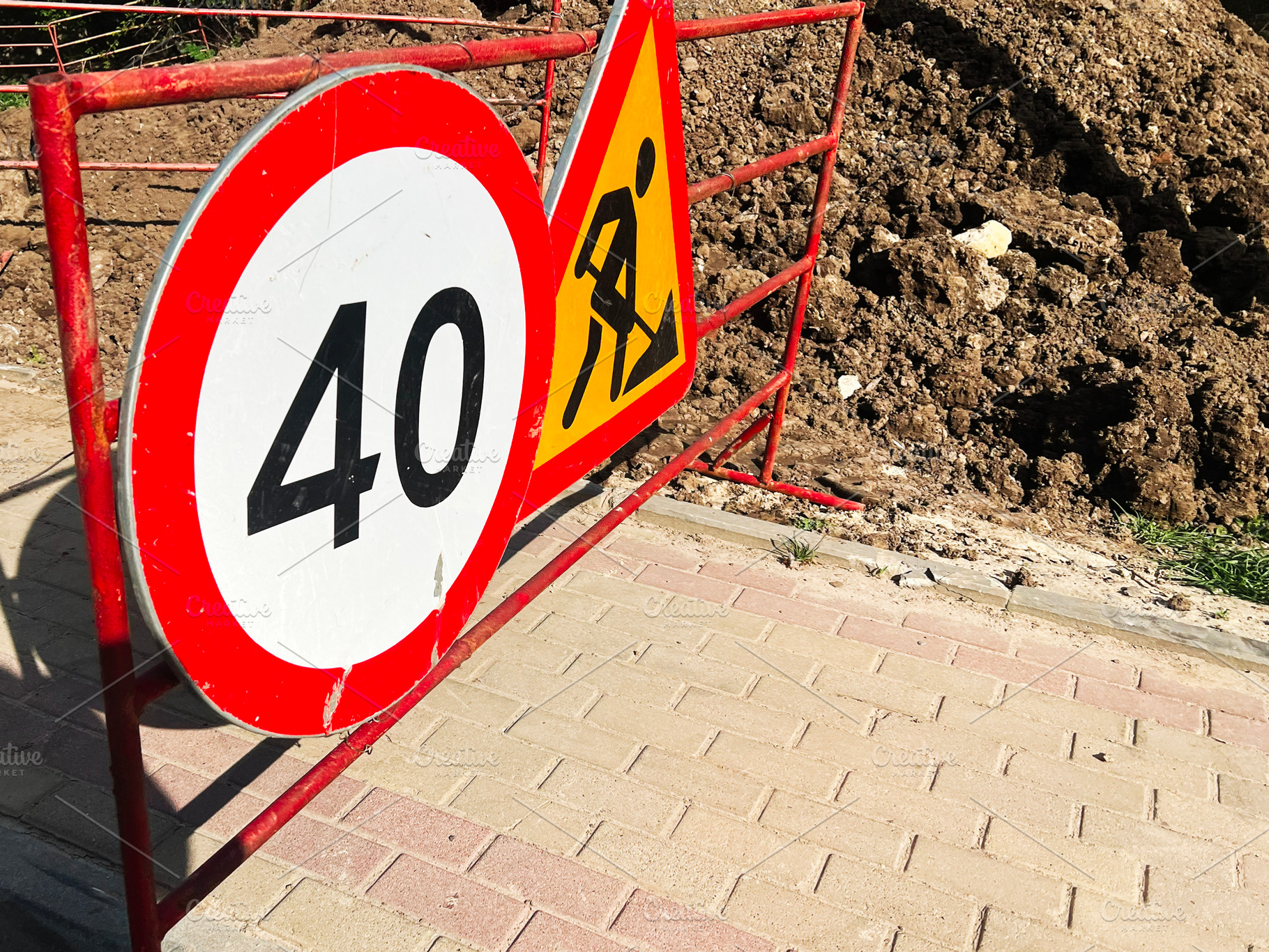 Roadside construction sign indicating speed limit near freshly dug soil, a Photo by AS photostudio