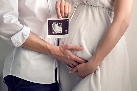 Pregnant girl holding with their containing medical, family, and woman, a Person Photo by SaulichPhoto