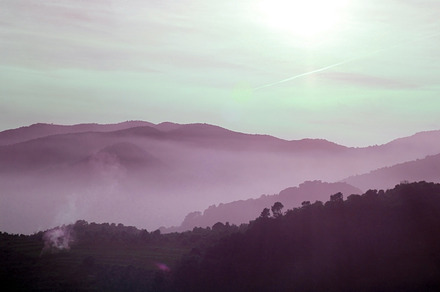 Foggy purple landscape featuring mountain, fog, and cloud