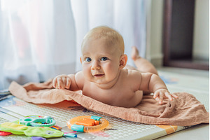 Little baby playing with toys on a, a Person Photo by Elizaveta Galitskaya