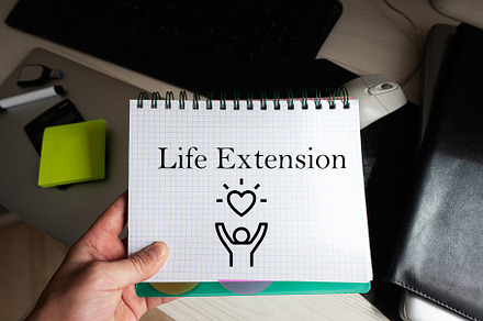 Life extension word on notebook holding man against desktop., a Background Photo by AS photostudio