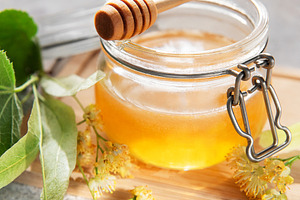 Linden honey jar with dipper and blossoms, a Food & Drink Photo by Olena Rudo