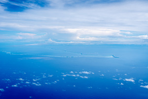 Aerial view of the Tuamotus atoll in French Polynesia with cloud, a Nature Photo by GoodGoods