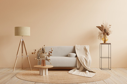 Boho style interior with gray sofa and decor on cream color wall.