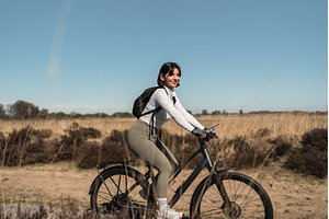 Female cyclist rides a sandy coastal, a Nature Photo by AD Stock Images