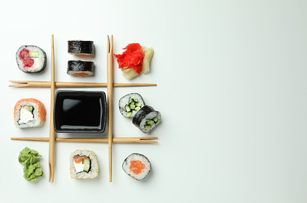 Concept of tasty food with sushi rolls on white background, a Food & Drink Photo by AtlasStudio
