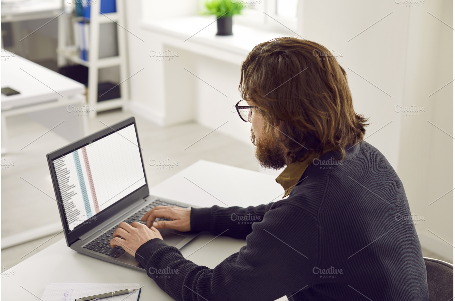 Man sitting at his office desk and, a Technology Photo by StudioRomantic