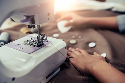 Closeup of sewing machine with dressmaker designing new fashion, a Beauty & Fashion Photo by Ministocker