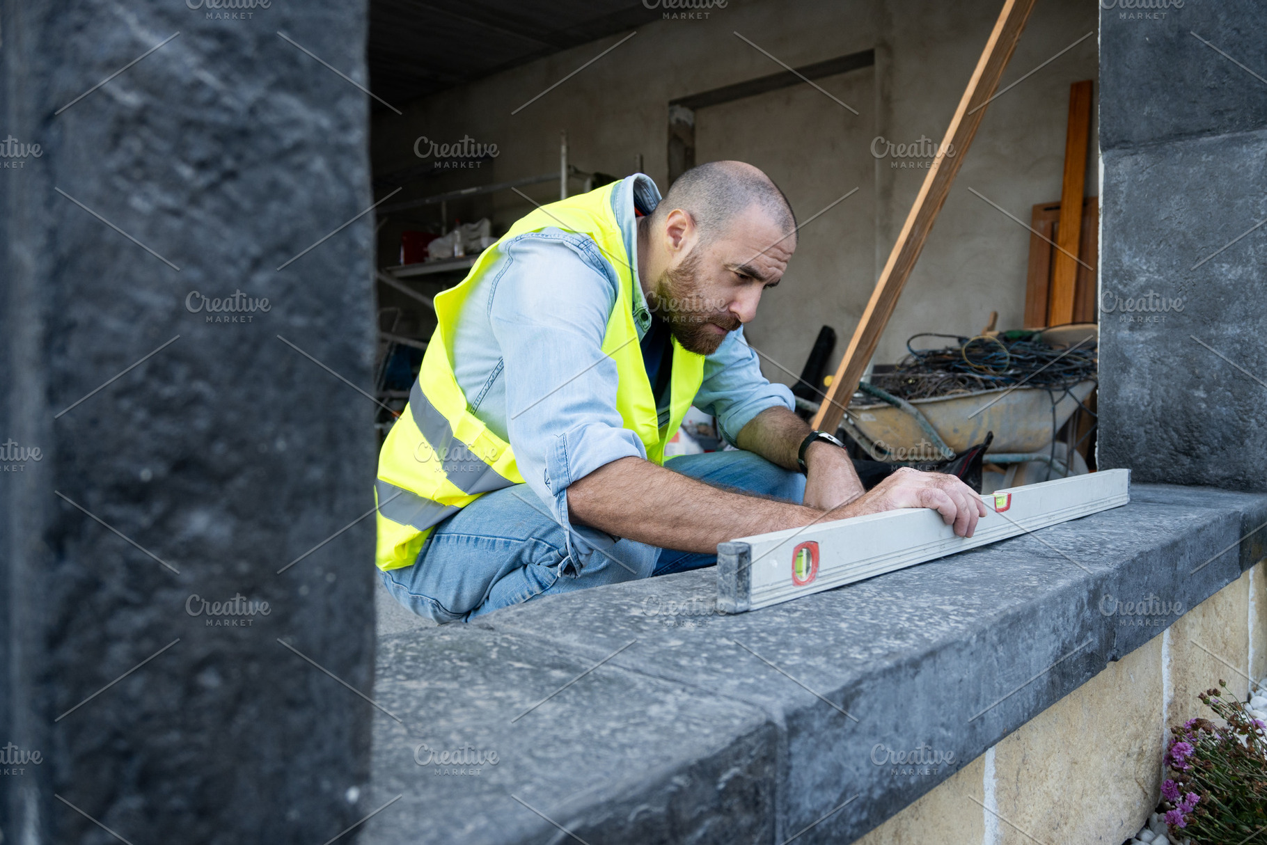 Construction worker leveling a stone surface outdoors, a Person Photo by etorres69