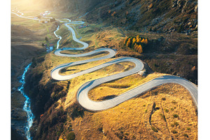 Aerial view of winding mountain road, a Transportation Photo by den-belitsky