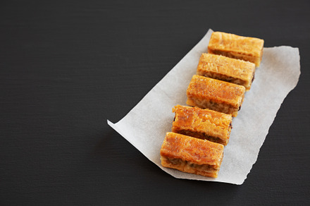 Homemade Baklavas with Honey, Chocolate and Almond on a black ba, a Food & Drink Photo by LiudmylaChuhunova