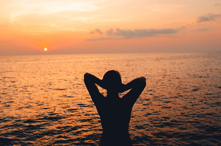 Sunset and Clouds over the Ocean,Woman watching the sun set, a Nature Photo by Art Rachen