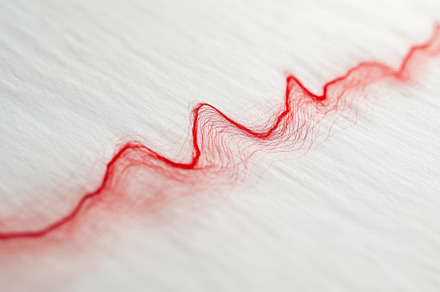 A vibrant red thread creates a zigza, a Photo by Tanuart
