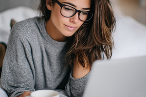 Young woman with glasses use laptop, a Person Photo by MistyDay