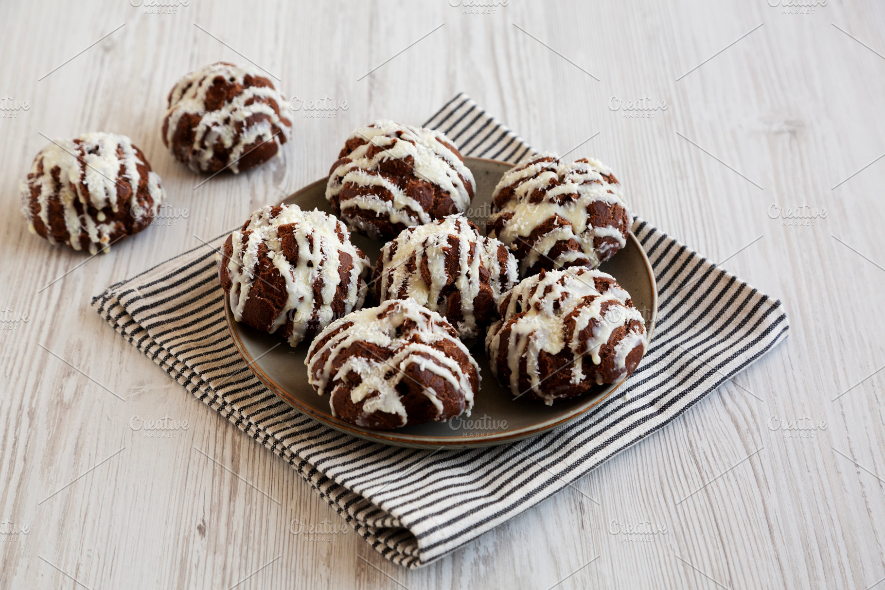 Homemade Profiteroles with Coconut Cream on a Plate, side view., a Food & Drink Photo by LiudmylaChuhunova