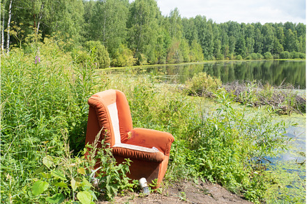Red chair on a green background, an Abstract Photo by KAA