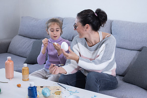 Mother and daughter painting Easter eggs, a Person Photo by etorres69