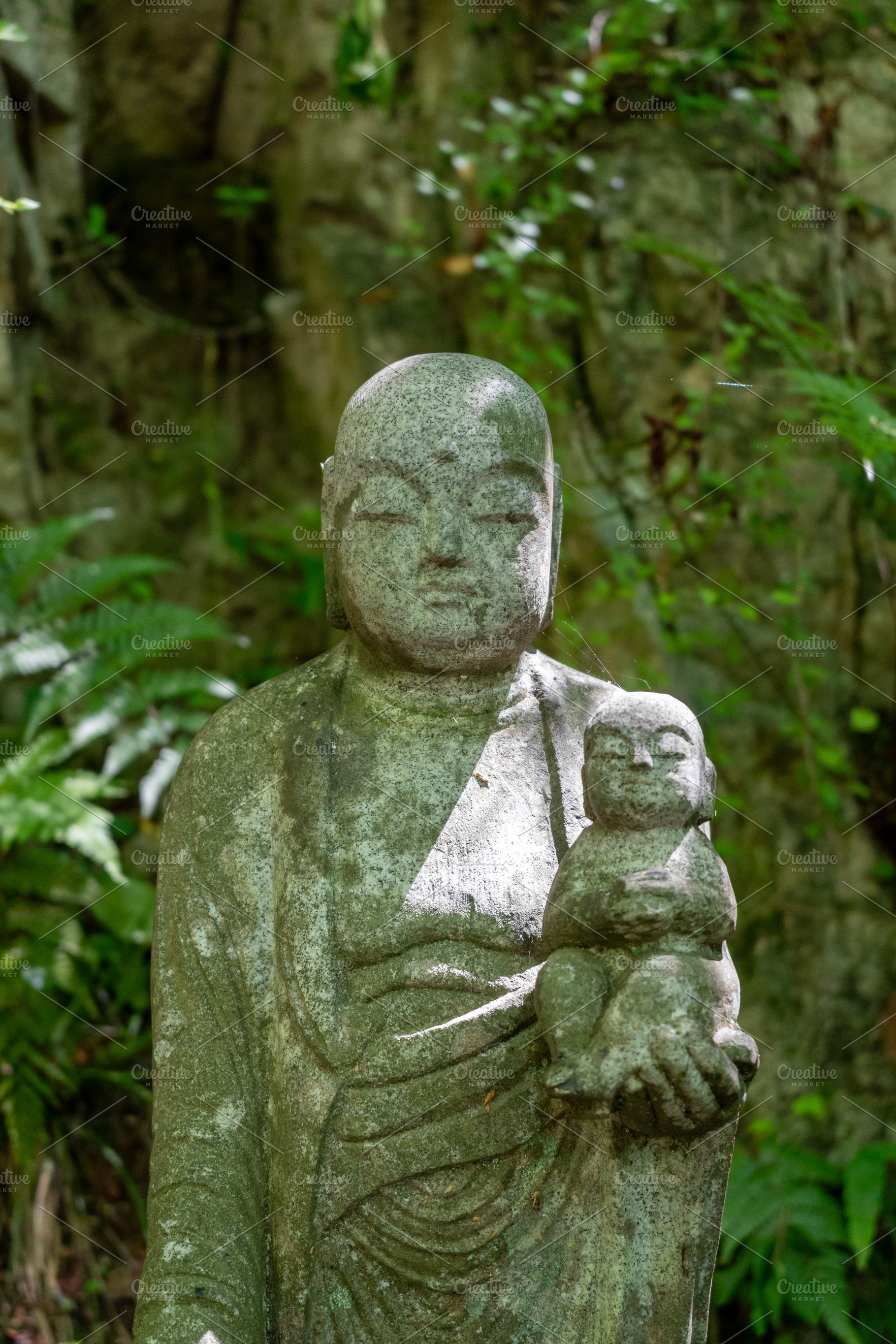 Jizo Bosatsu statue holding baby at Mitaki-Dera in Hiroshima, an Arts & Entertainment Photo by GoodGoods