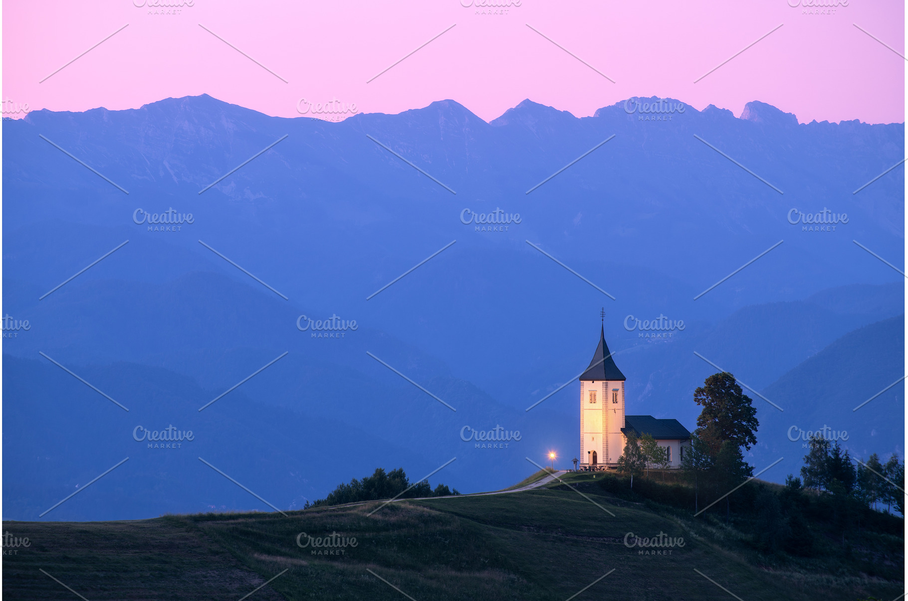 Church on a hill at dusk with, a Nature Photo by den-belitsky