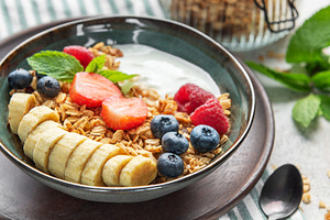 Healthy breakfast bowl with yogurt, granola, banana, and berries, a Food & Drink Photo by Olena Rudo