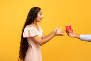 Holiday celebration concept. Male hand holding and giving wrapped gift box to s, a Photo by Prostock-Studio (Thumbnail 1 of 3)