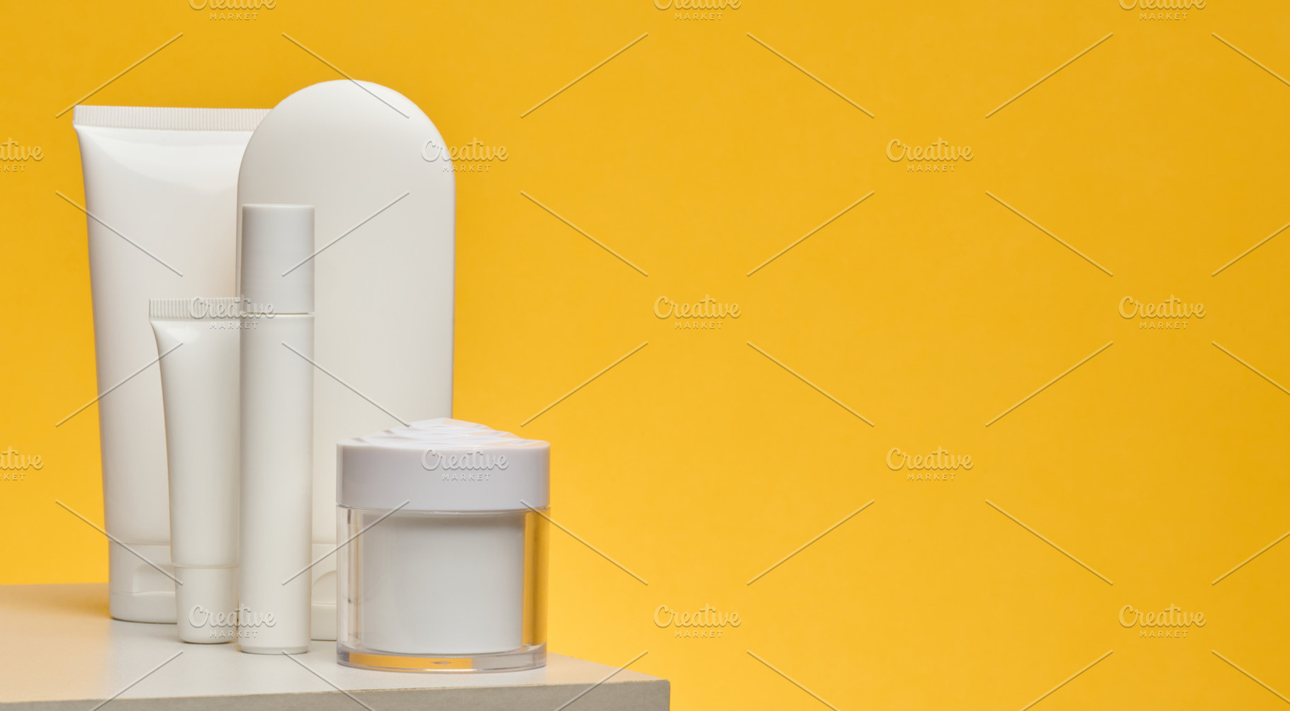 Set of white cosmetic packaging without brand on yellow backgrou, a Health & Medical Photo by ndanko