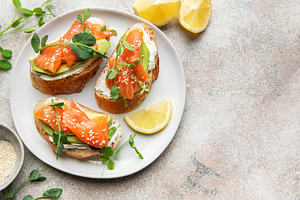 Smoked salmon avocado toast with seeds and sprouts, a Food & Drink Photo by Olena Rudo