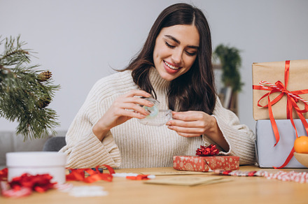 Woman wrapping Christmas Presents Gifts