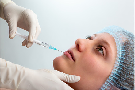 Cosmetic surgeon injecting botox to, a Health & Medical Photo by WildMedia