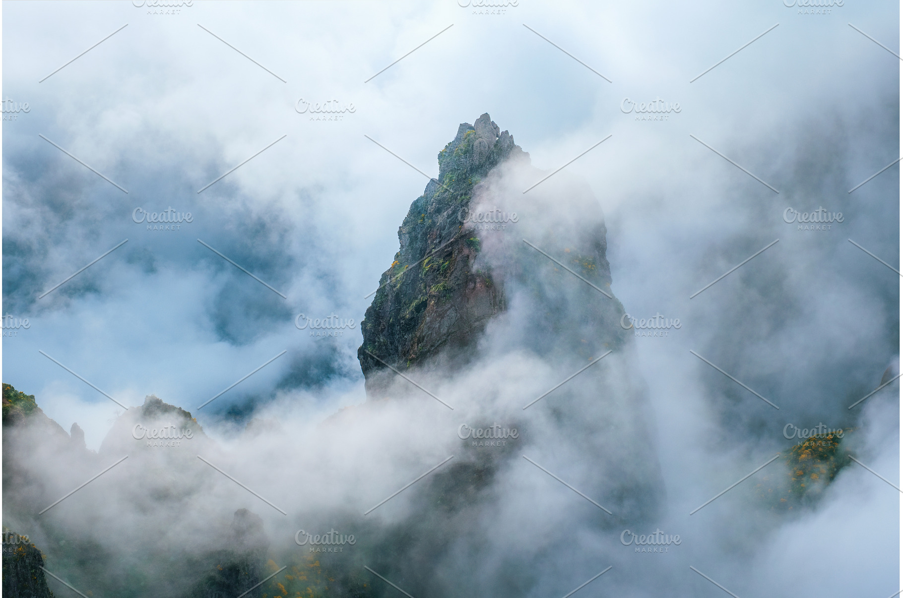 A mountain covered in fog and clouds, a Nature Photo by f9photos
